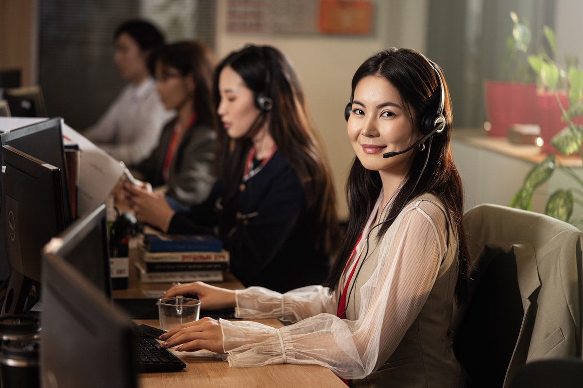 Support engineer with headset at a desk